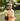 Young boy holding a skateboard outdoors in a park